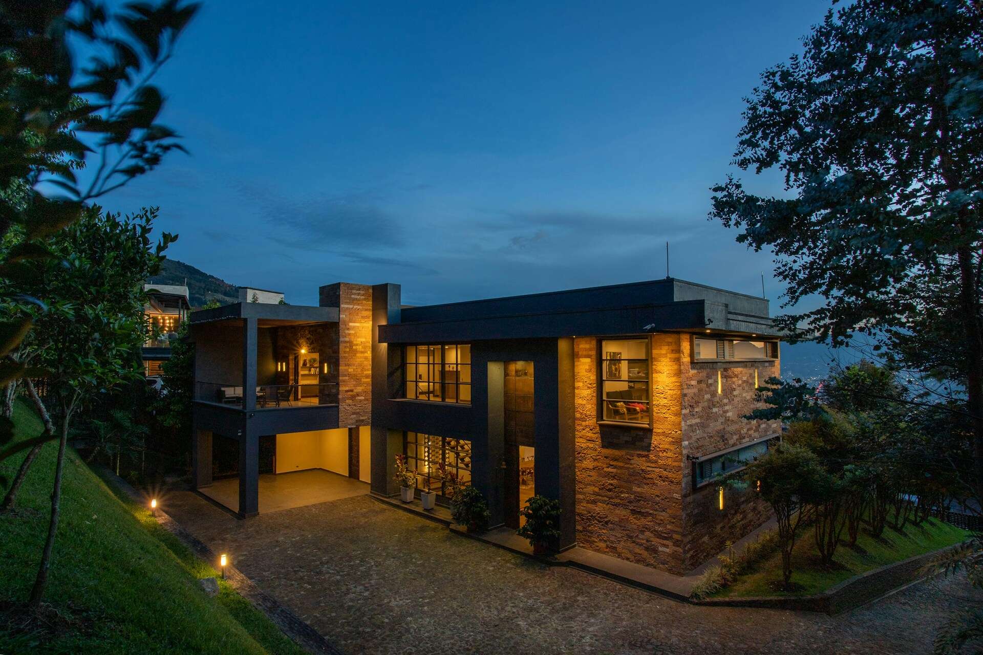 a house with a lot of windows lit up at night