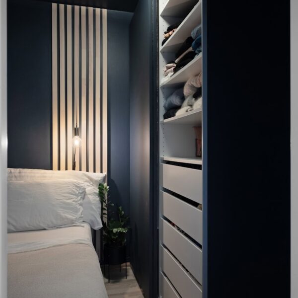 A bedroom with a bed and a closet
